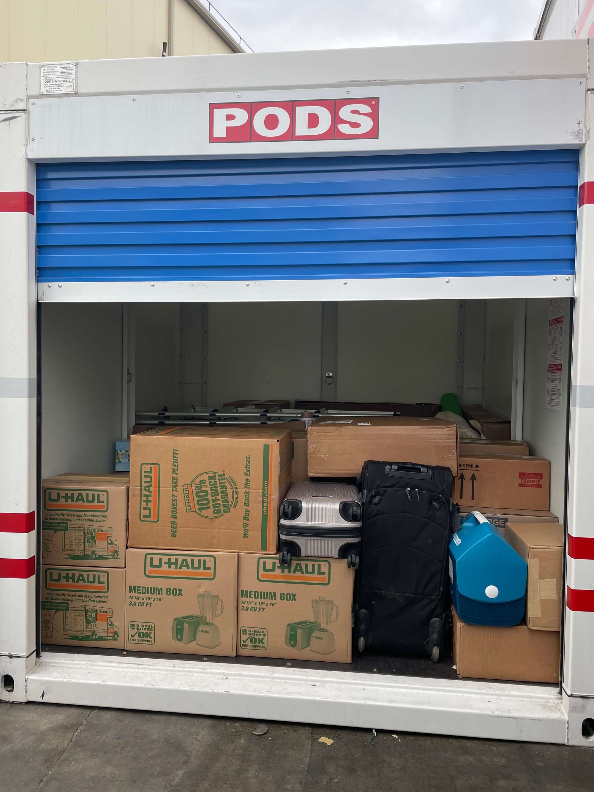 A PODS, 8-foot storage unit filled less than halfway with boxes.