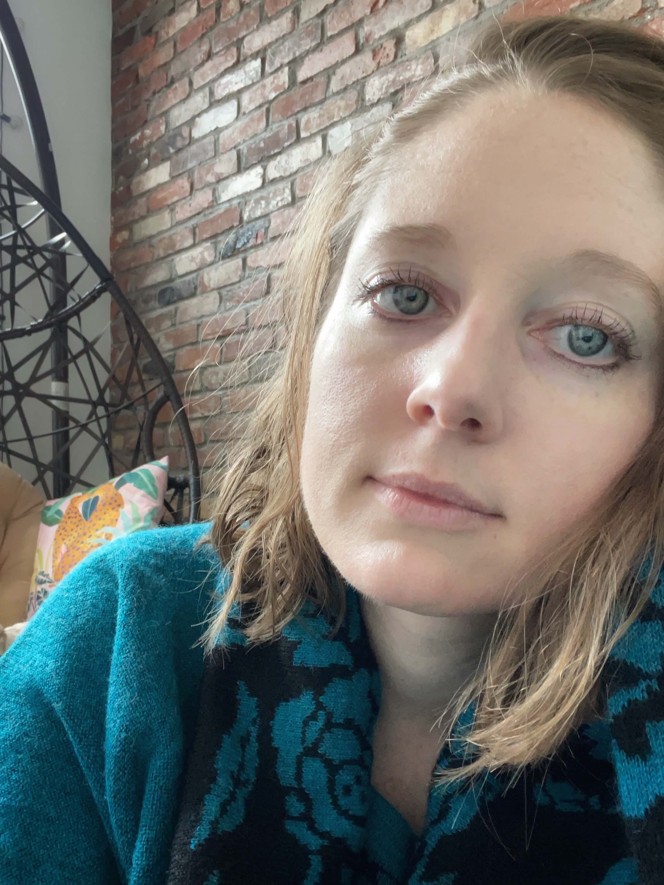 Clara Ritger looking directly at the camera with sad eyes.