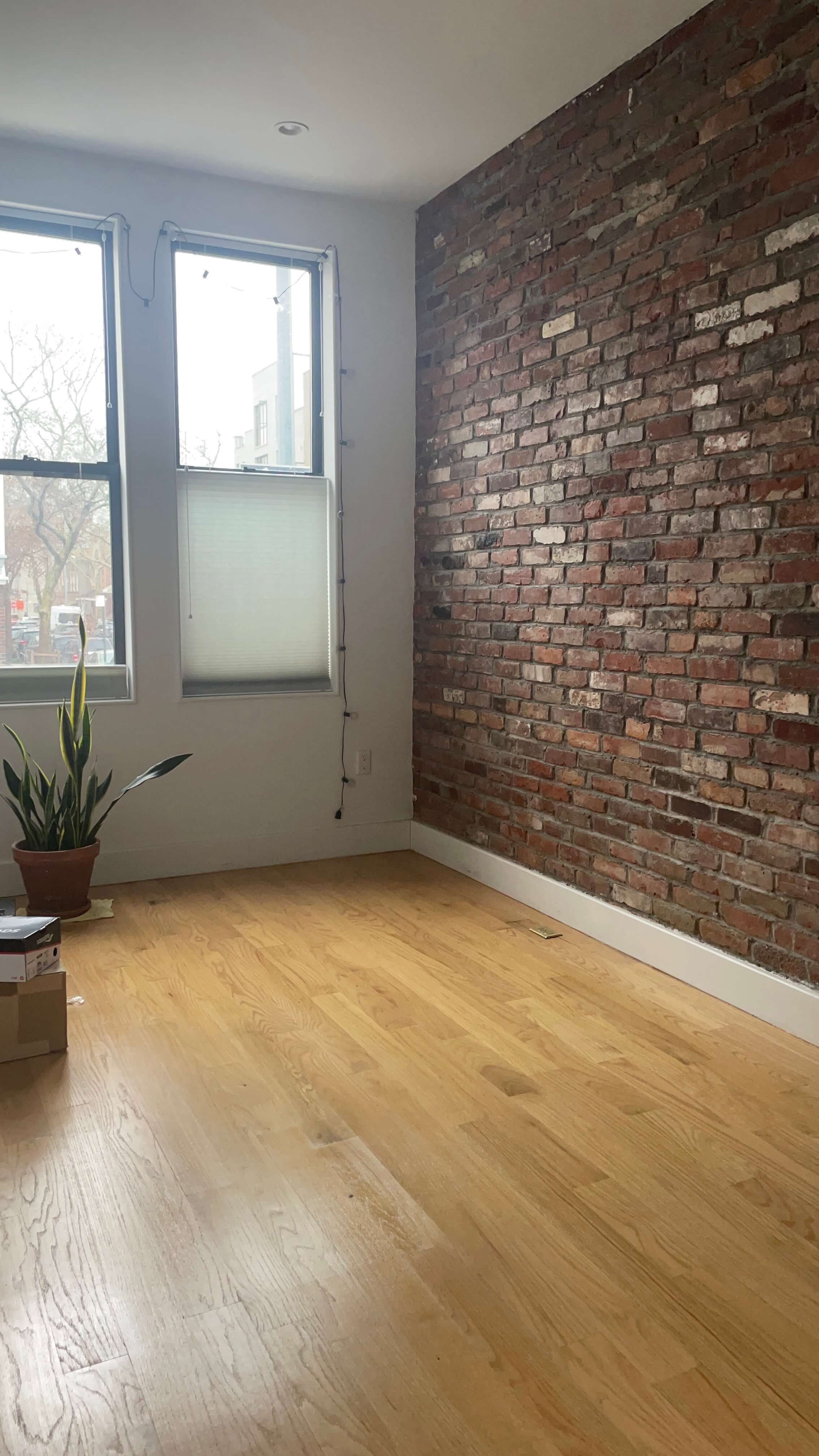 The same vantage point of the brick wall without furniture.