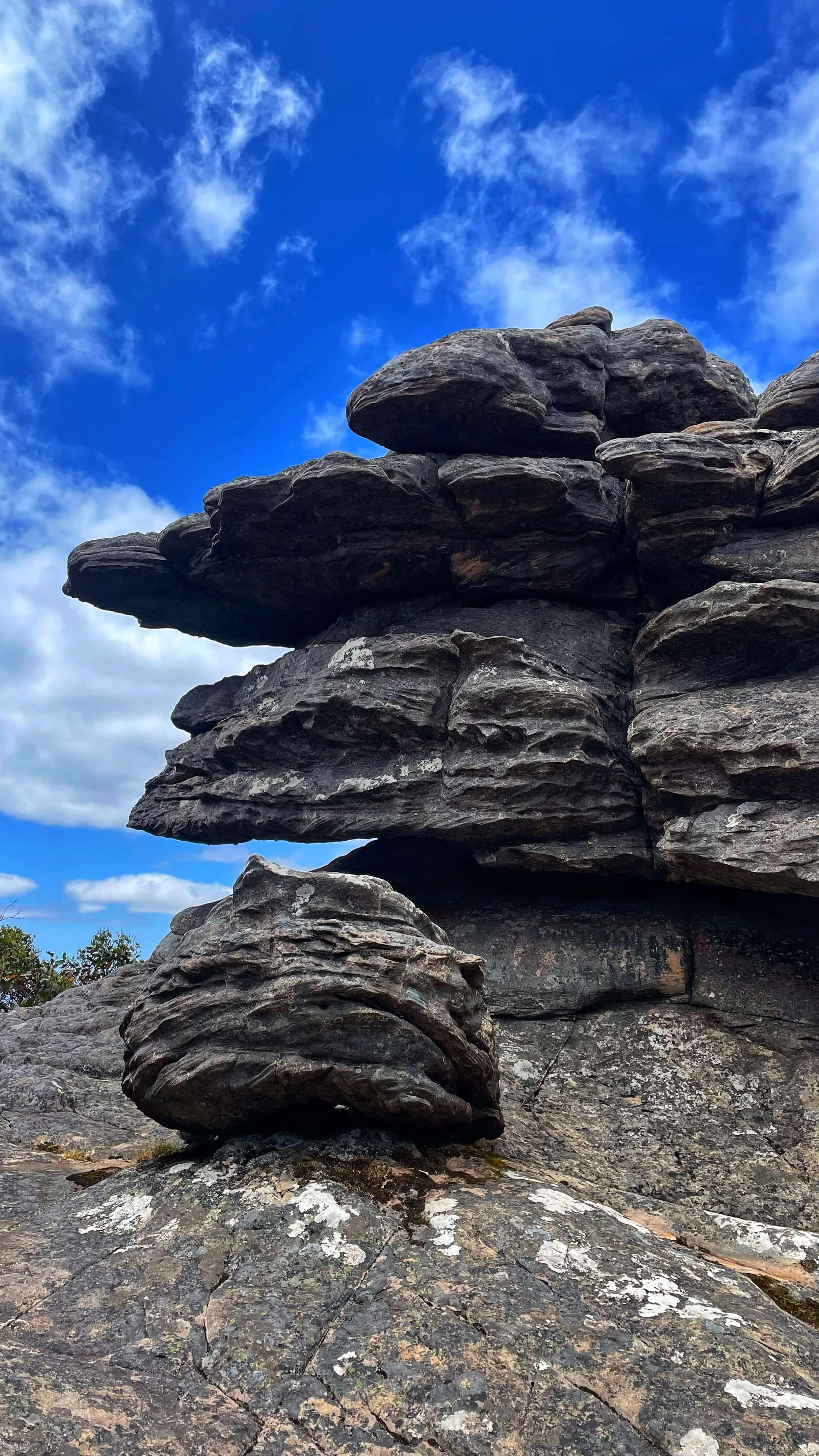 Tall boulders form with ridges and layers, at different sizes, almost resembling circular spaceships.