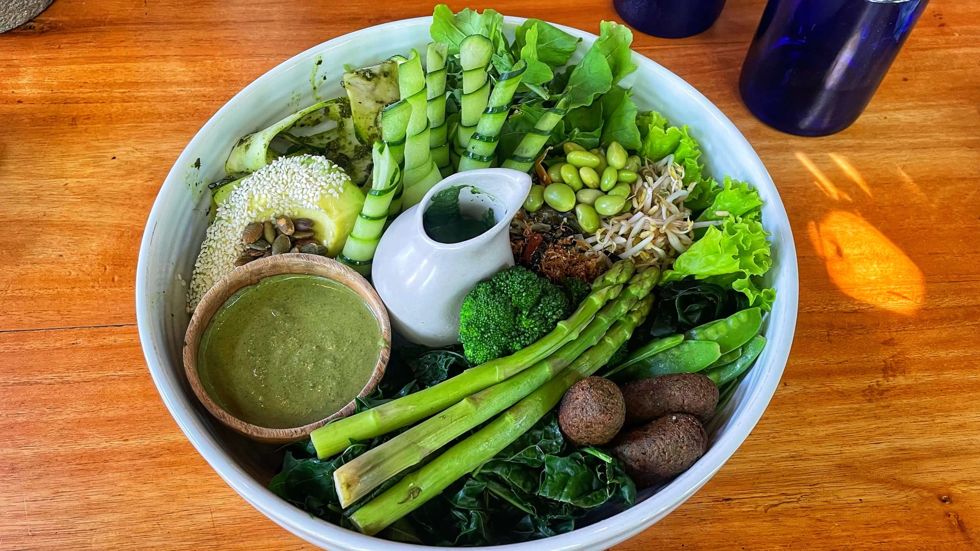 A big bowl filled with every green vegetable you can think of.