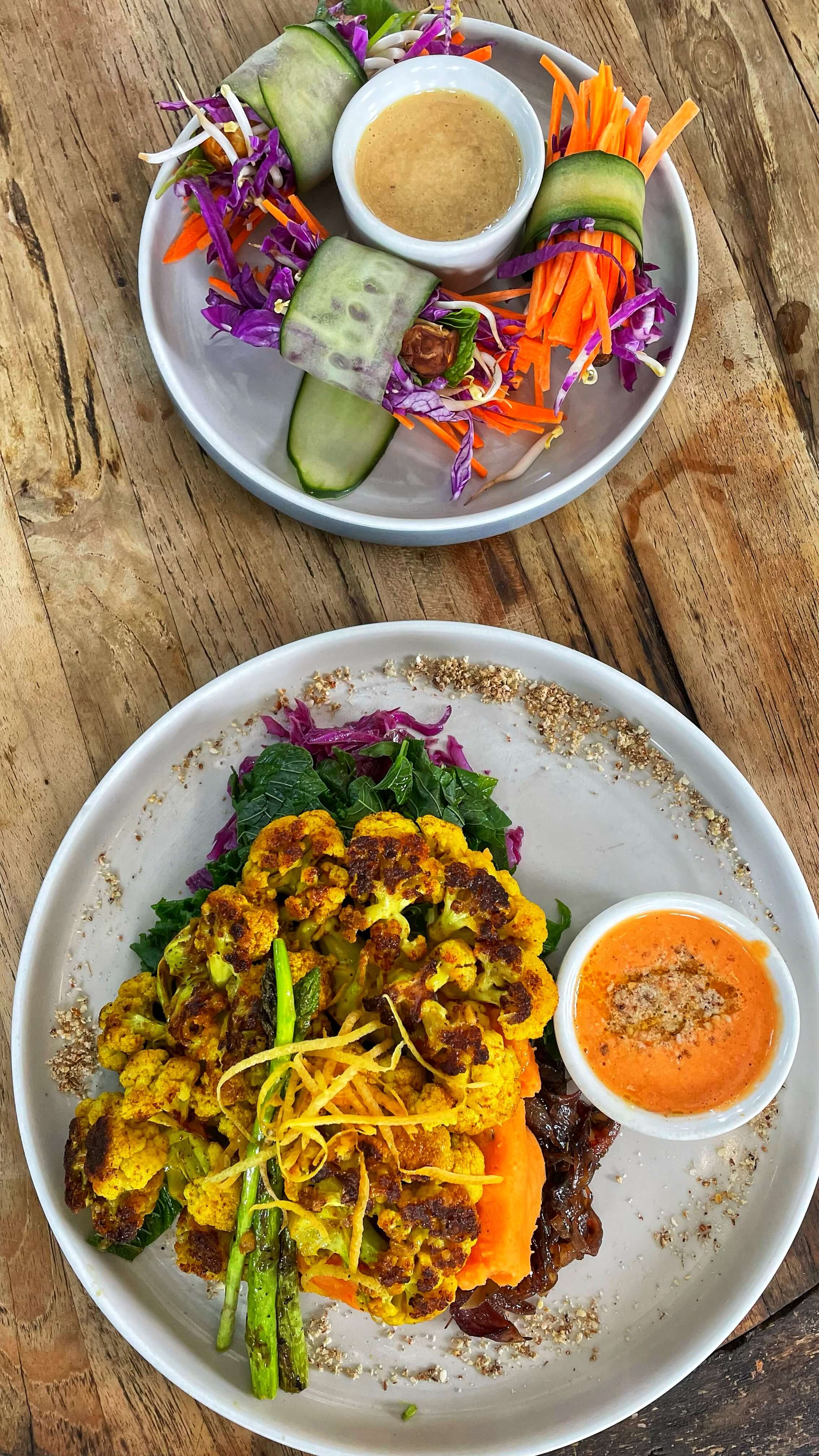 Cucumber wraps carrots, cabbage and tempe, and a curry cauliflower steak with grilled asparagus rests atop sauteed spinach and a sweet potato puree.