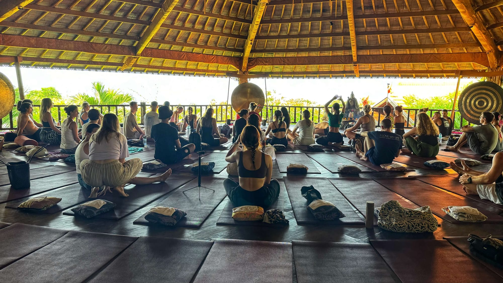 People arrive to their mats in a yoga shala that can hold more than 50 people. 