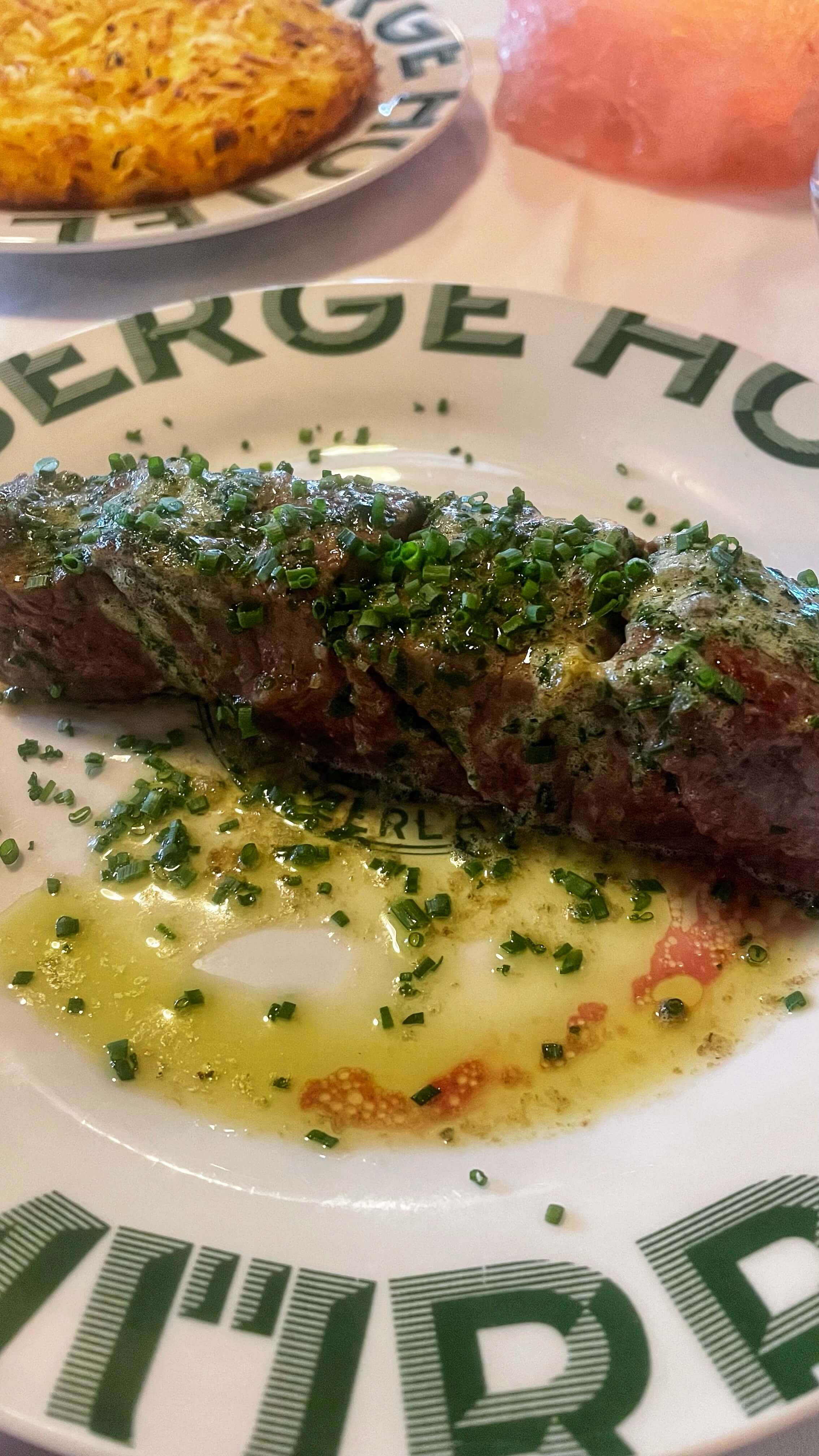 A buttery slab of meat covered in chives.