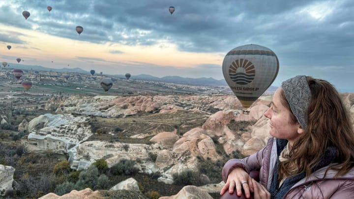 Clara Ritger looks at sunrise over Cappadocia, Turkey, where hot air balloons fly over rock formations unique to the region.