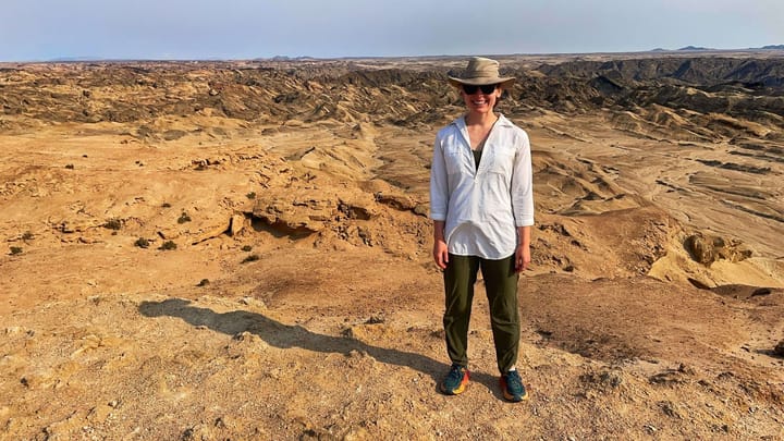 Clara Ritger poses in front of a desert landscape in Namibia.