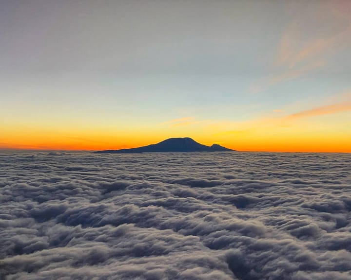 Mount Kilimanjaro above the clouds at sunrise.