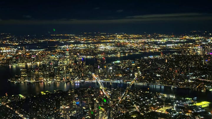 Downtown New York City at night, from an aerial view.